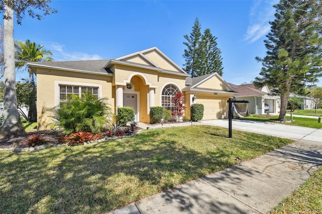 view of front of home with a garage, driveway, a front lawn, and stucco siding