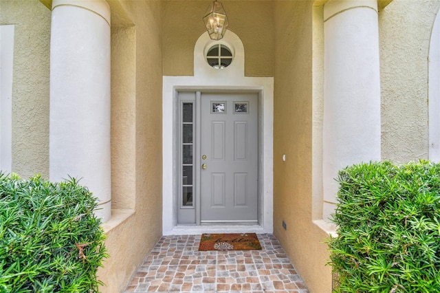 doorway to property with stucco siding