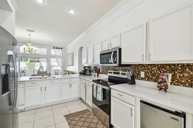 kitchen featuring light tile patterned floors, ornamental molding, a sink, stainless steel appliances, and backsplash