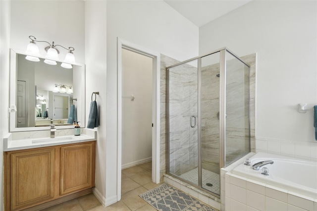 bathroom featuring a stall shower, vanity, a bath, and tile patterned floors