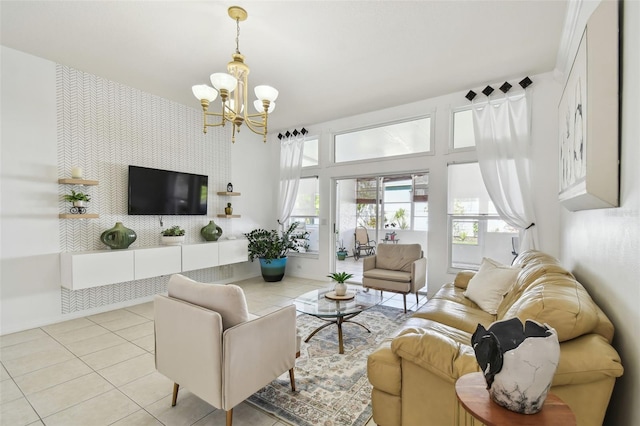 living room featuring tile patterned floors, a notable chandelier, an accent wall, and wallpapered walls