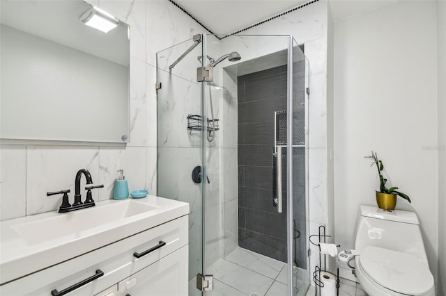 bathroom with toilet, a stall shower, vanity, and tile walls