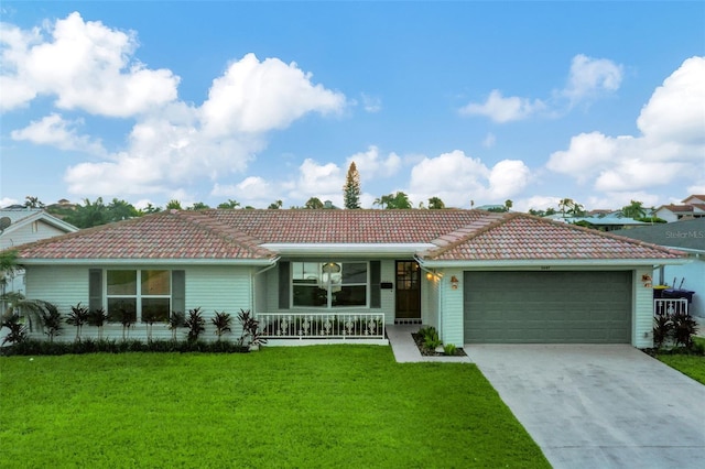 ranch-style house featuring a garage, a porch, and a front yard