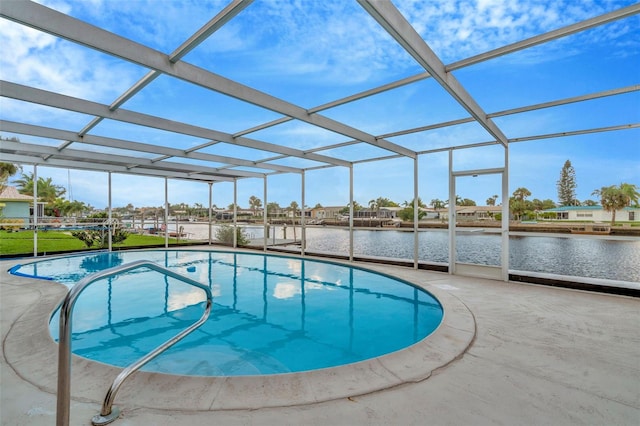 view of swimming pool featuring a patio, a water view, and glass enclosure