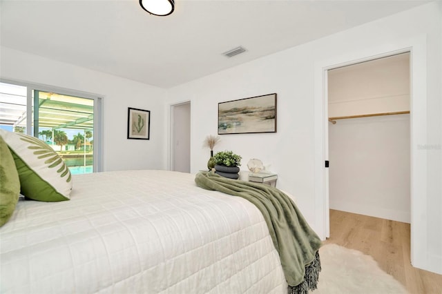 bedroom featuring light hardwood / wood-style floors and a closet