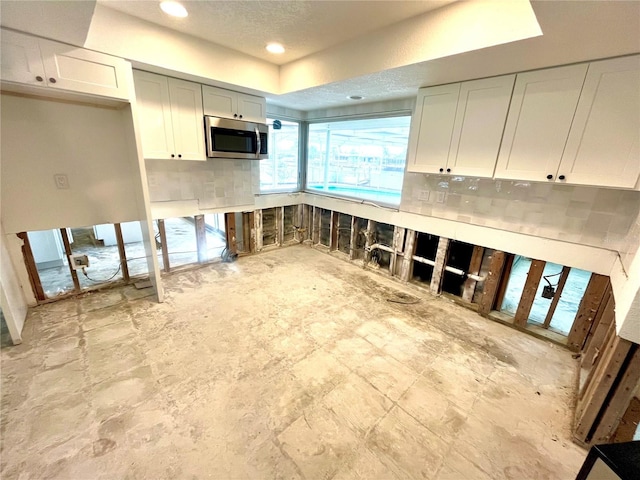 kitchen with white cabinets and backsplash