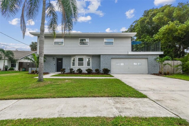 view of front property featuring a garage and a front yard