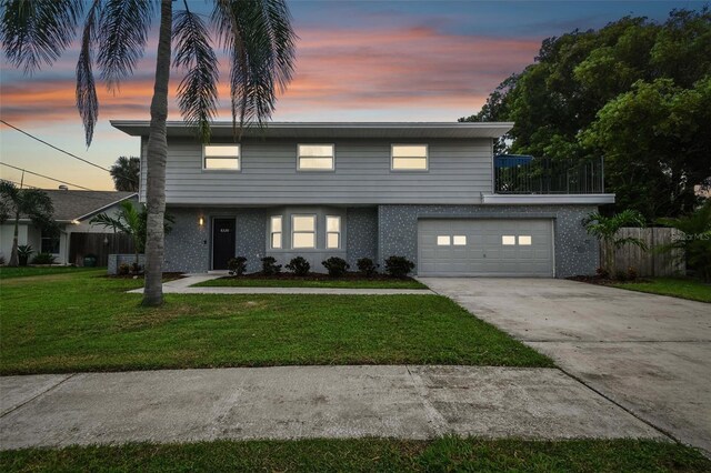 view of front of property featuring a yard and a garage