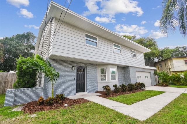 view of front of home with a garage and a front lawn