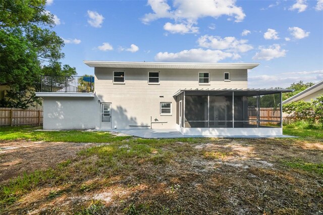 back of house featuring a sunroom and a patio area