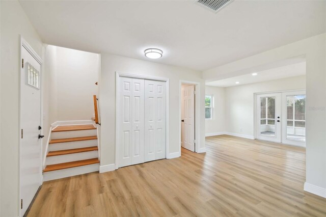 interior space featuring french doors and light hardwood / wood-style floors