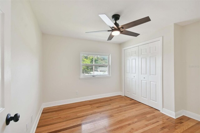 unfurnished bedroom with ceiling fan, a closet, and light hardwood / wood-style flooring