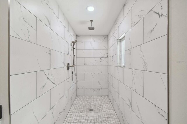 bathroom with a tile shower