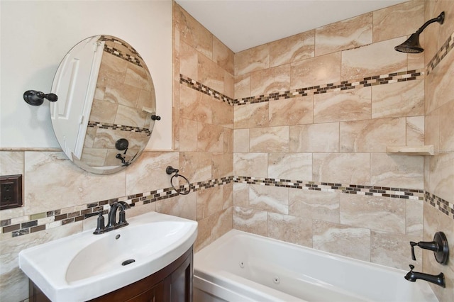 bathroom with tile walls, vanity, and tiled shower / bath combo