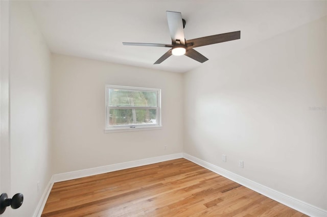 spare room featuring light wood-style flooring, baseboards, and ceiling fan