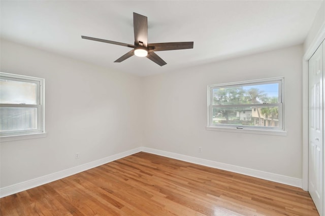 empty room with light hardwood / wood-style flooring and ceiling fan