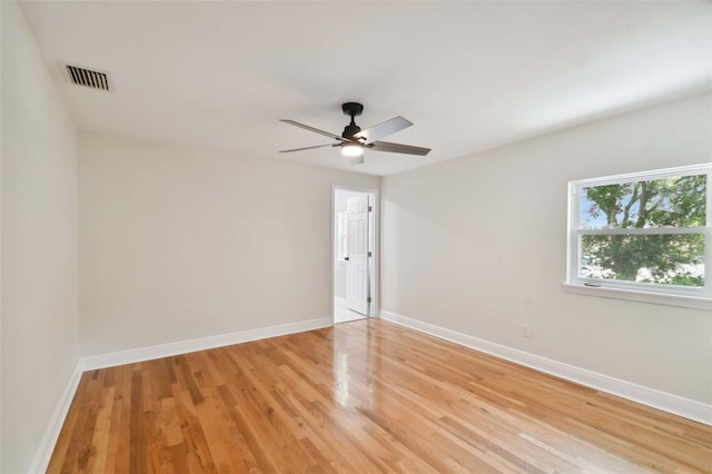 unfurnished room with a ceiling fan, light wood-style flooring, visible vents, and baseboards