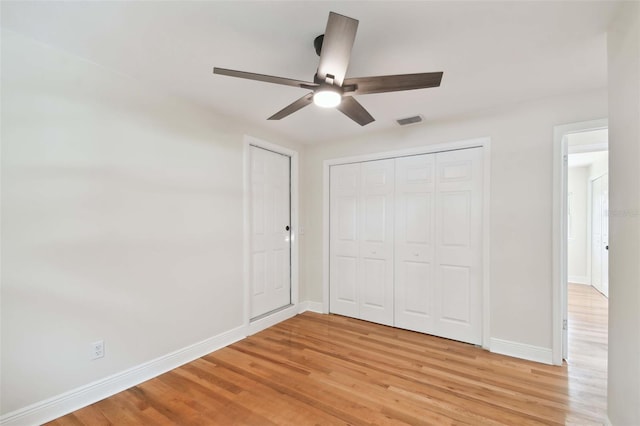 unfurnished bedroom with a closet, ceiling fan, and light hardwood / wood-style flooring