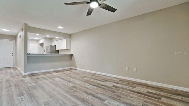 unfurnished living room with ceiling fan and light hardwood / wood-style floors