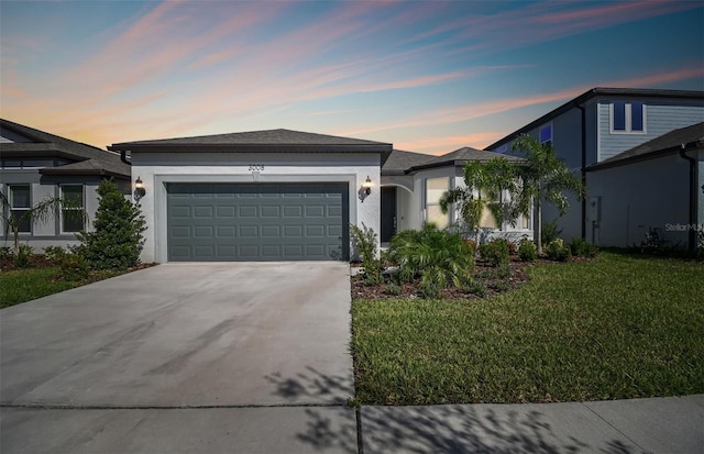 view of front of property with a garage and a lawn