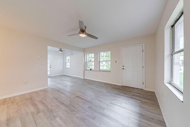 empty room with ceiling fan and light wood-type flooring