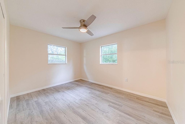 spare room featuring ceiling fan, plenty of natural light, and light hardwood / wood-style floors