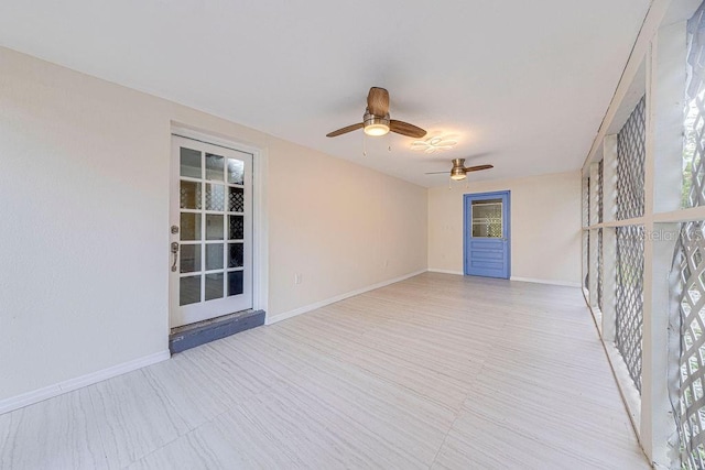 unfurnished room featuring ceiling fan and a healthy amount of sunlight