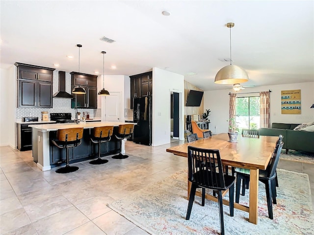 dining area featuring light tile patterned floors and visible vents