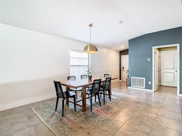 dining area with light tile patterned floors, baseboards, and visible vents