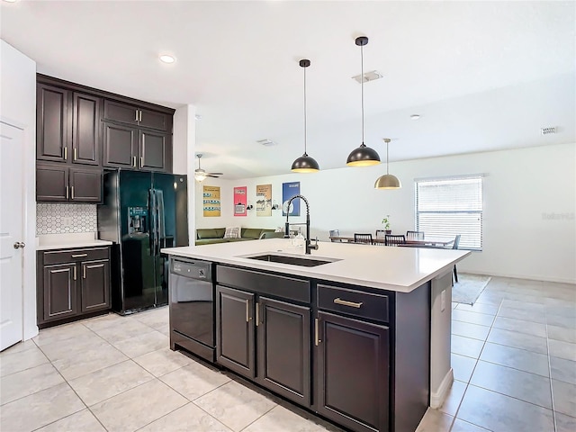 kitchen with light countertops, visible vents, light tile patterned flooring, a sink, and black appliances