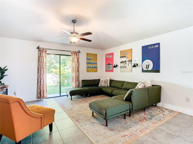 living area featuring a ceiling fan, tile patterned flooring, and baseboards