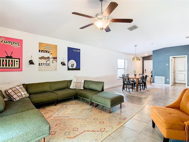 living area with light tile patterned floors, visible vents, and a ceiling fan