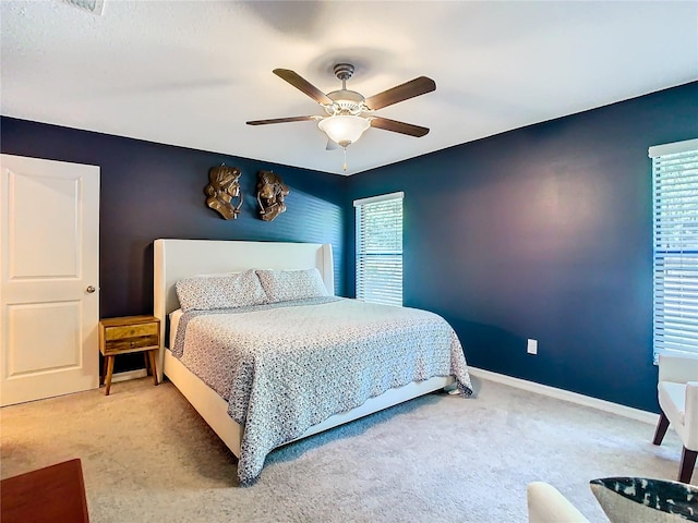 bedroom featuring ceiling fan, baseboards, and carpet flooring