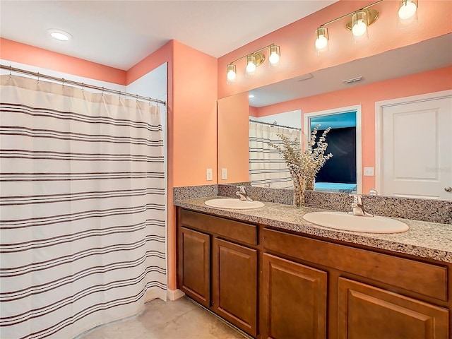 full bathroom featuring tile patterned floors, visible vents, a sink, and double vanity