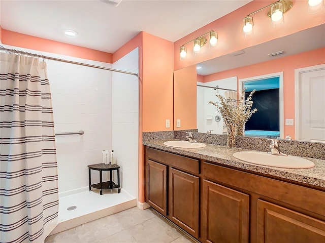 bathroom featuring curtained shower, visible vents, a sink, and double vanity