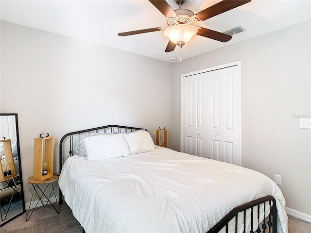 bedroom with a closet, visible vents, carpet flooring, ceiling fan, and baseboards