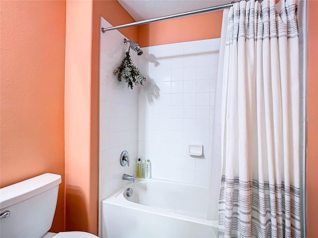 bathroom with shower / bath combination with curtain and toilet