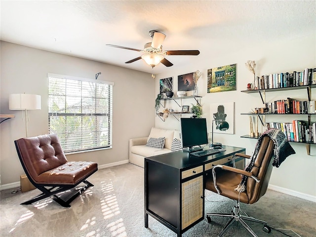 carpeted office featuring ceiling fan and baseboards