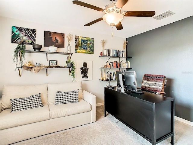 carpeted home office featuring ceiling fan, visible vents, and baseboards