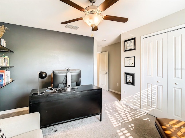 carpeted office featuring visible vents, ceiling fan, and baseboards