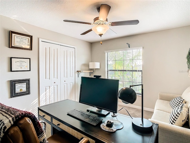 office area featuring a ceiling fan, carpet flooring, a textured ceiling, and baseboards