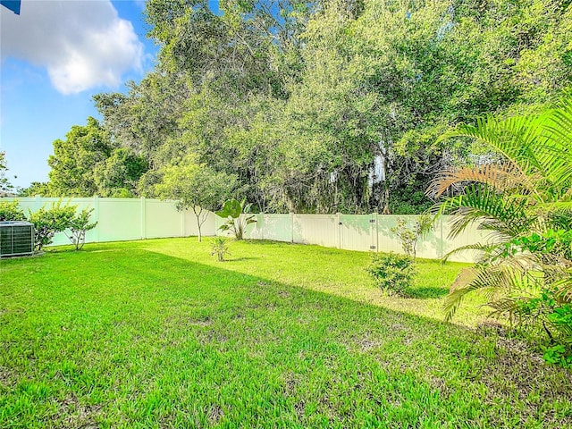 view of yard with cooling unit and a fenced backyard