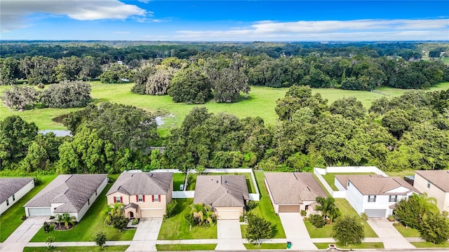 birds eye view of property with a residential view and a wooded view