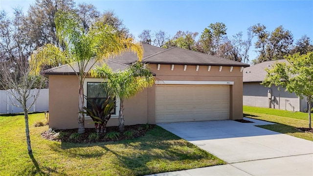 view of front of house with driveway, fence, a front lawn, and stucco siding