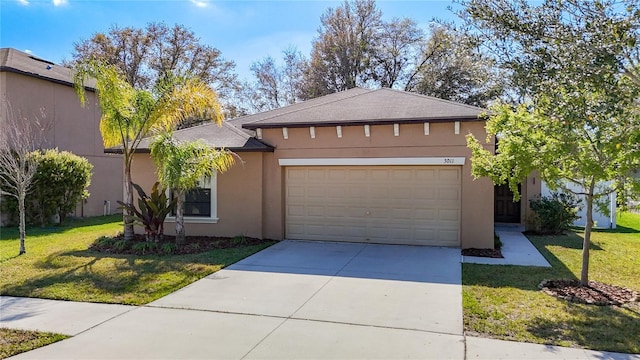 view of front of home featuring a front lawn, concrete driveway, an attached garage, and stucco siding