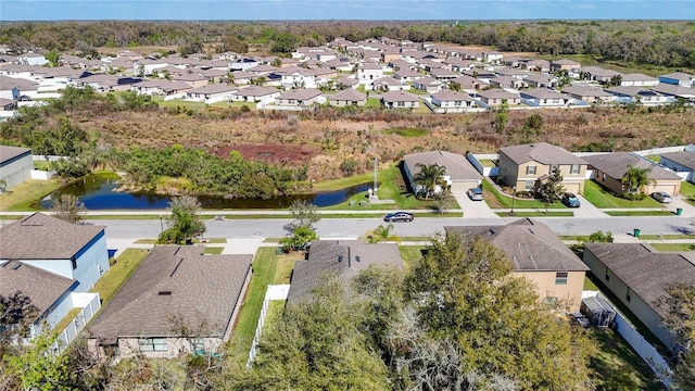 birds eye view of property with a water view and a residential view