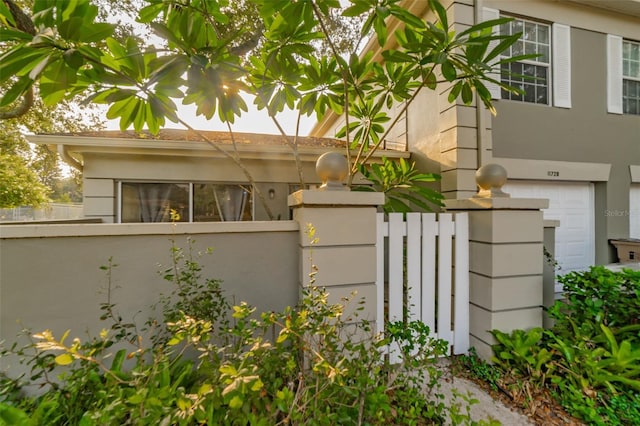 view of home's exterior featuring a fenced front yard and stucco siding