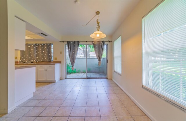 interior space with light tile patterned flooring and sink