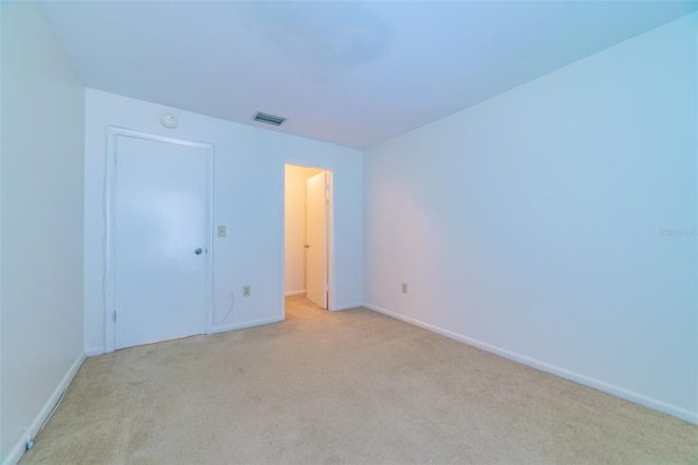 unfurnished bedroom with baseboards, visible vents, and light colored carpet