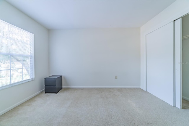 unfurnished bedroom featuring carpet and a closet